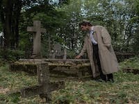 sad man at a cemetery