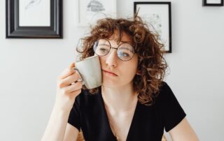 curly-haired-woman-holding-a-coffee-mug